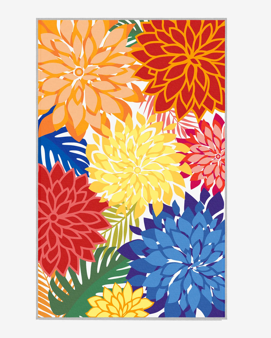Colorful floral outdoor area rug with bold red, yellow, orange, and blue dahlias