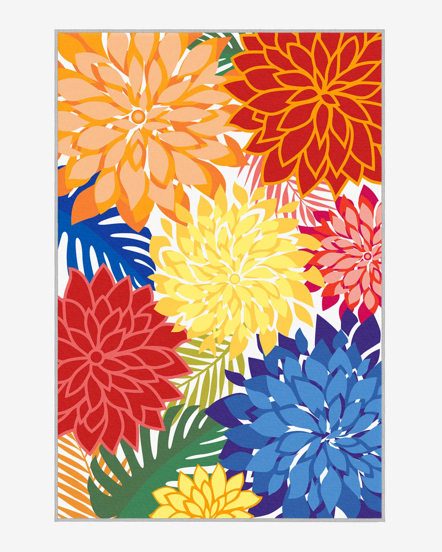 Colorful floral outdoor area rug with bold red, yellow, orange, and blue dahlias