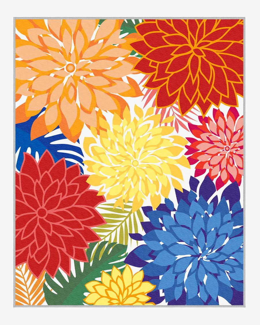 Colorful floral outdoor area rug with bold red, yellow, orange, and blue dahlias