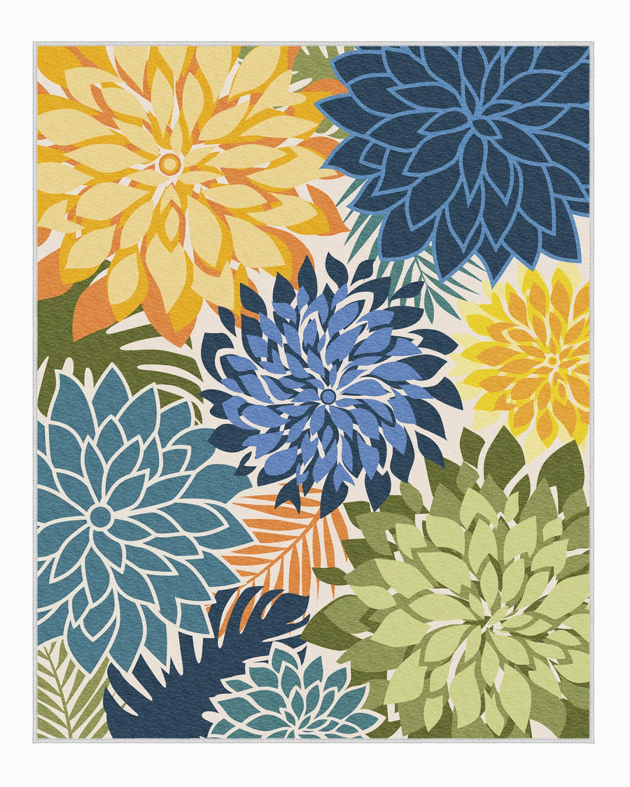 Washable Floral outdoor rug with oversized blue, yellow, and green dahlia pattern