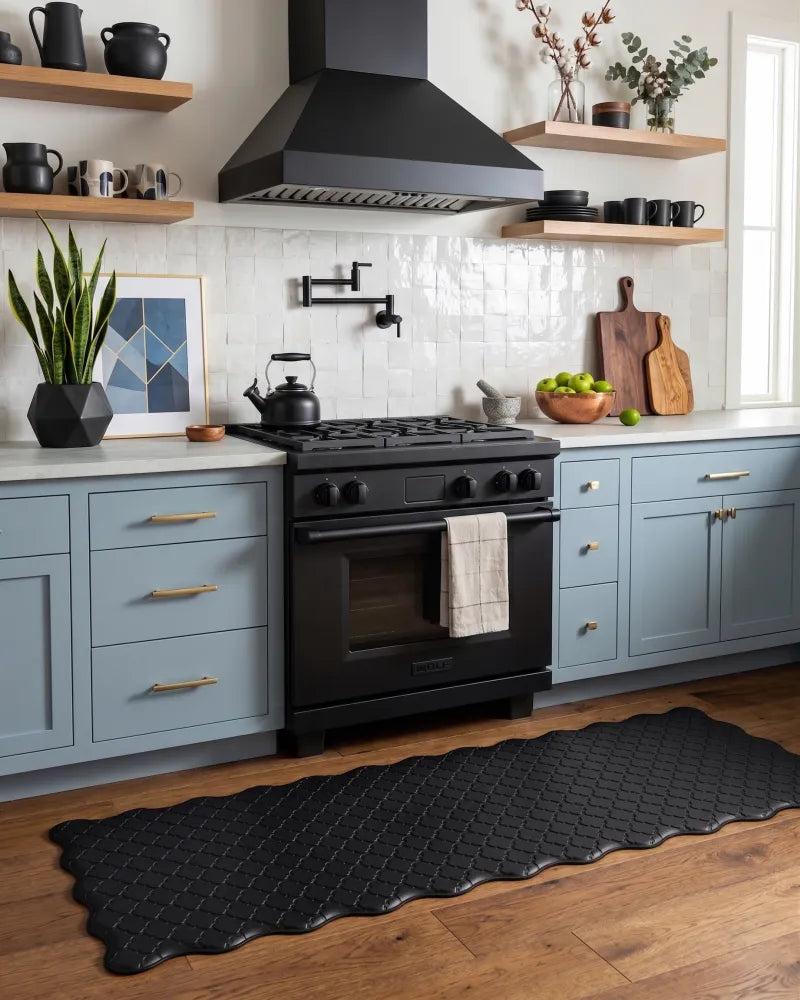 Black scalloped anti-fatigue kitchen runner in front of the stove in a modern kitchen