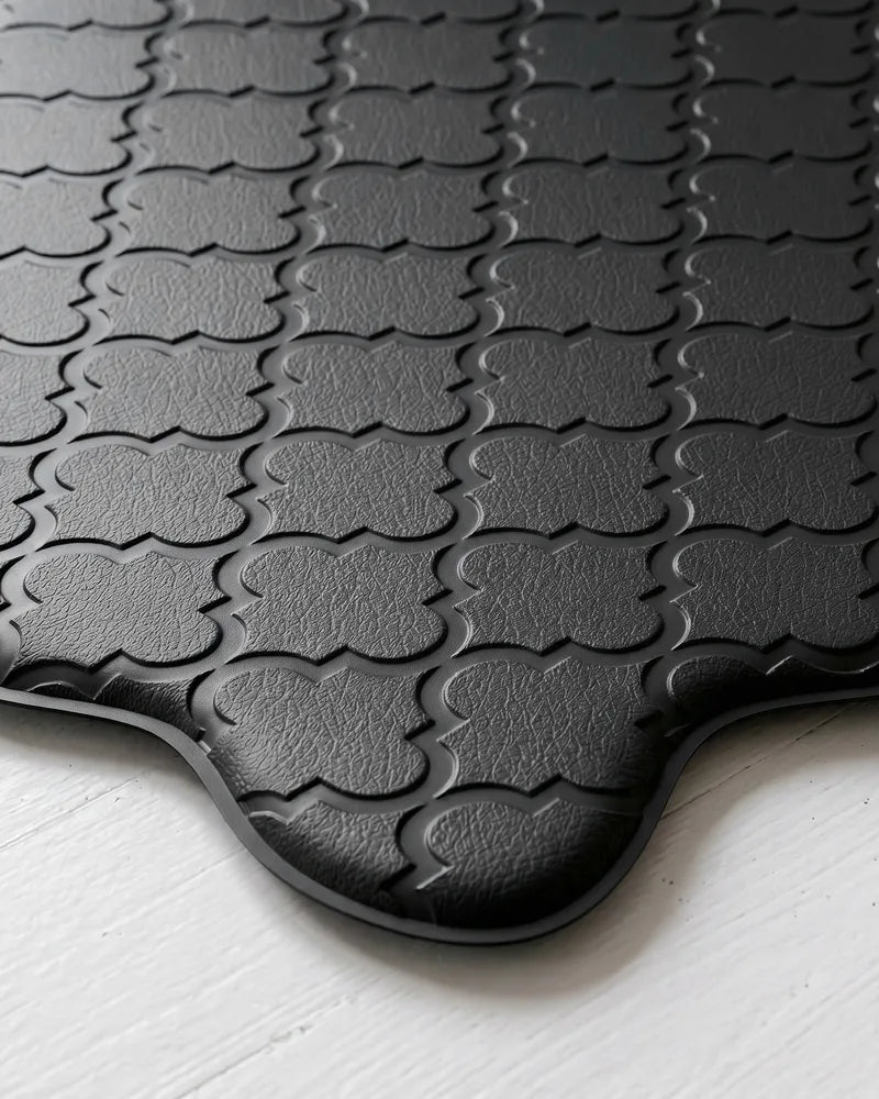Close-up of black scalloped kitchen mat with embossed texture