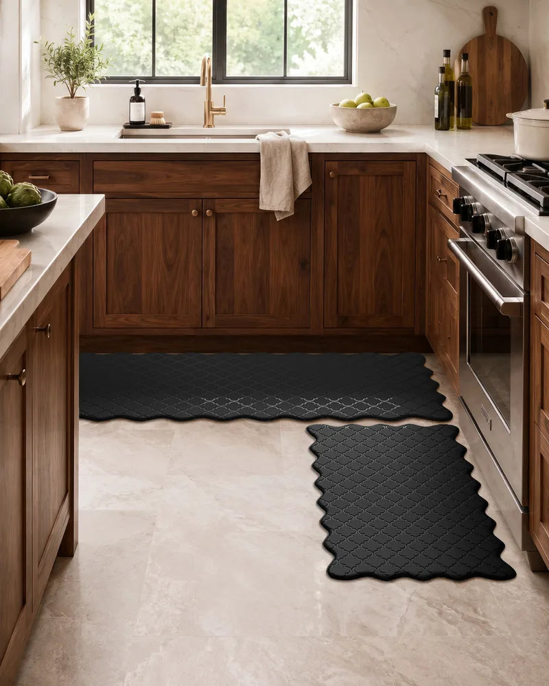 Black scalloped anti-fatigue kitchen mat set with wood cabinets