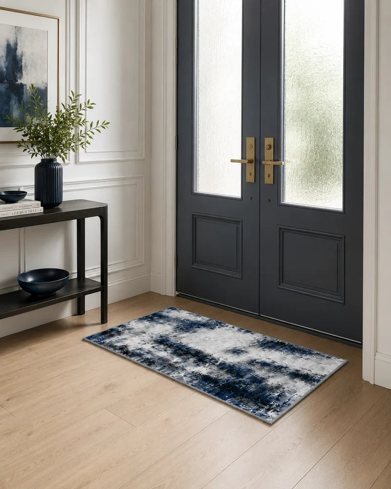 Blue gray washable foyer rug in front of dark double doors