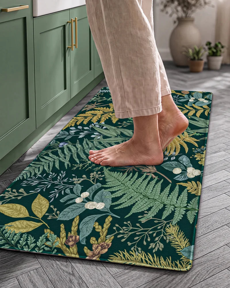 Bare feet standing on a Forest Green cushioned botanical kitchen mat