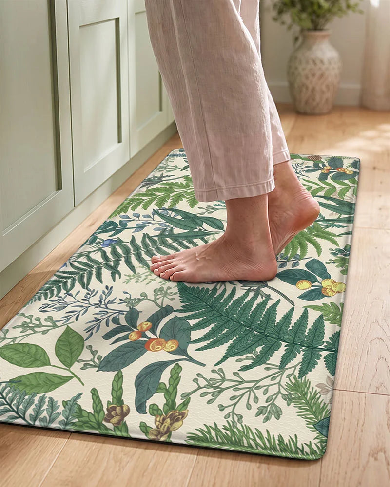 Bare feet standing on a Vintage Beige cushioned botanical kitchen mat