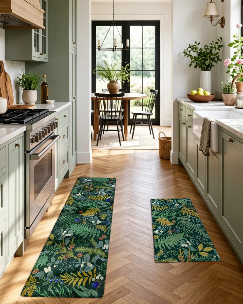 Forest Green botanical kitchen mats beside the sink and stove in a galley kitchen