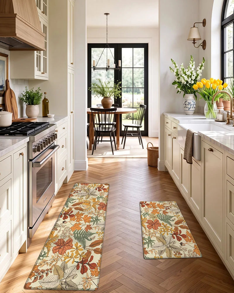 Maple Orange botanical kitchen mat set arranged between a kitchen island and sink