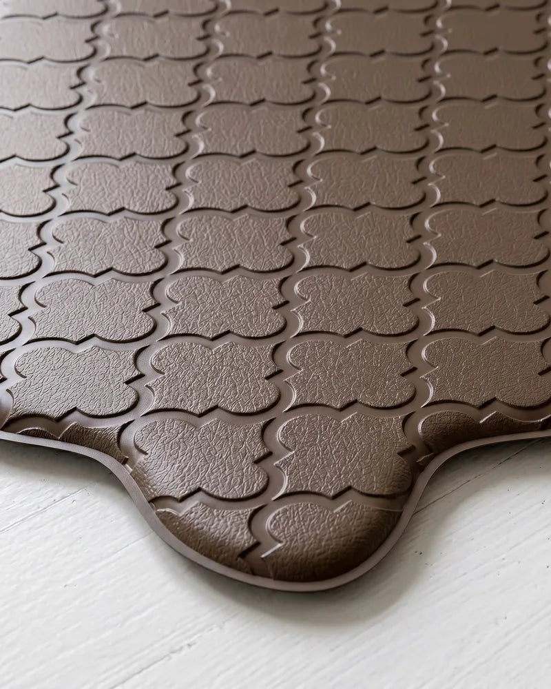 Close-up of brown scalloped kitchen mat with embossed texture
