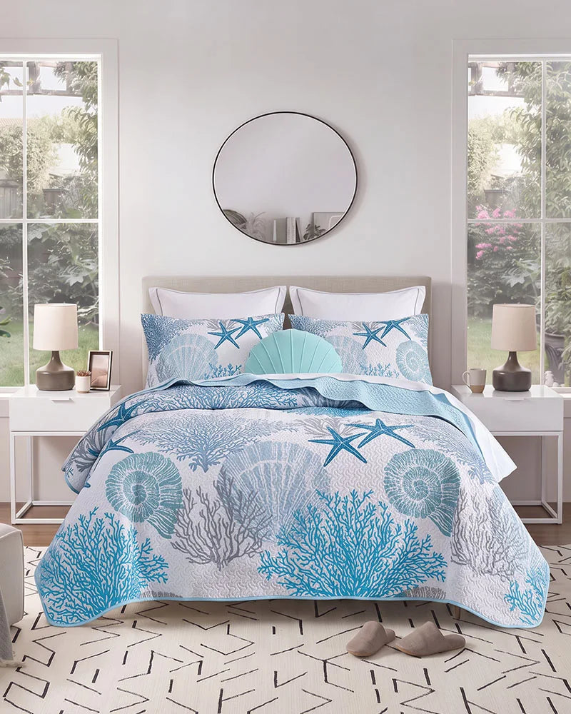 Aqua blue coral and starfish coastal quilt set in a bright modern bedroom