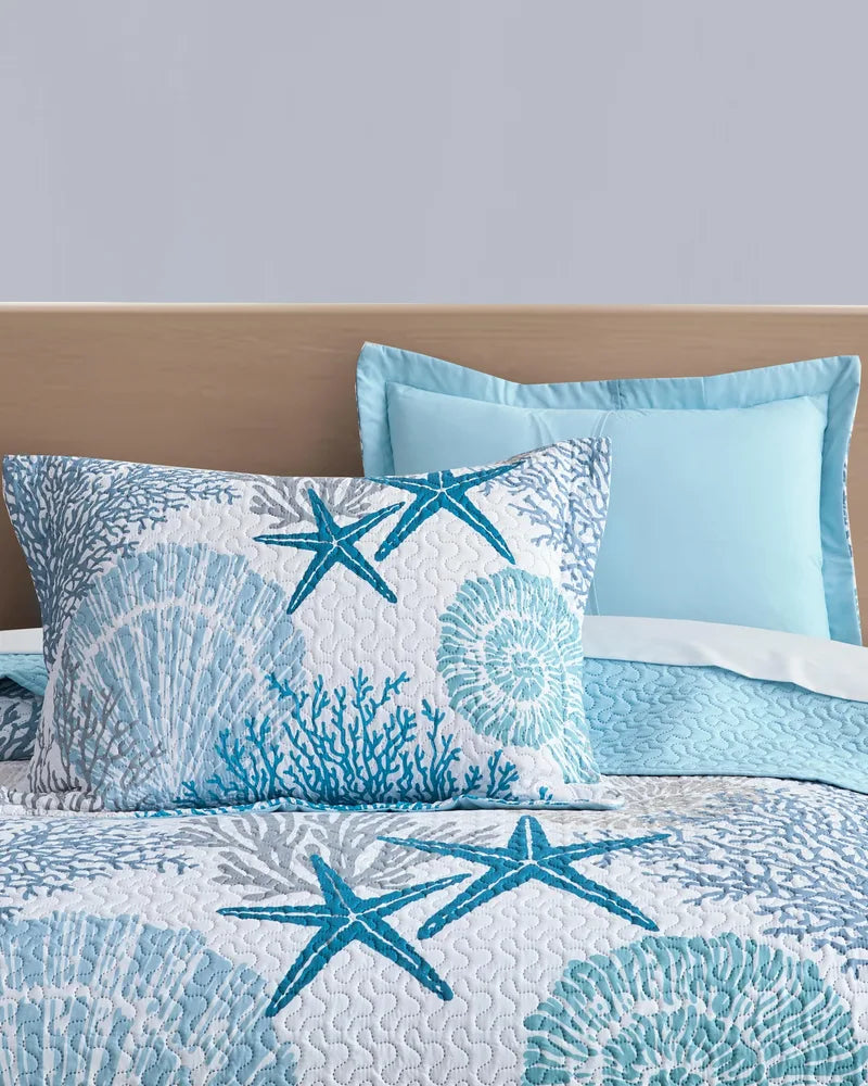 Matching pillow shams with blue coral and starfish coastal quilt set
