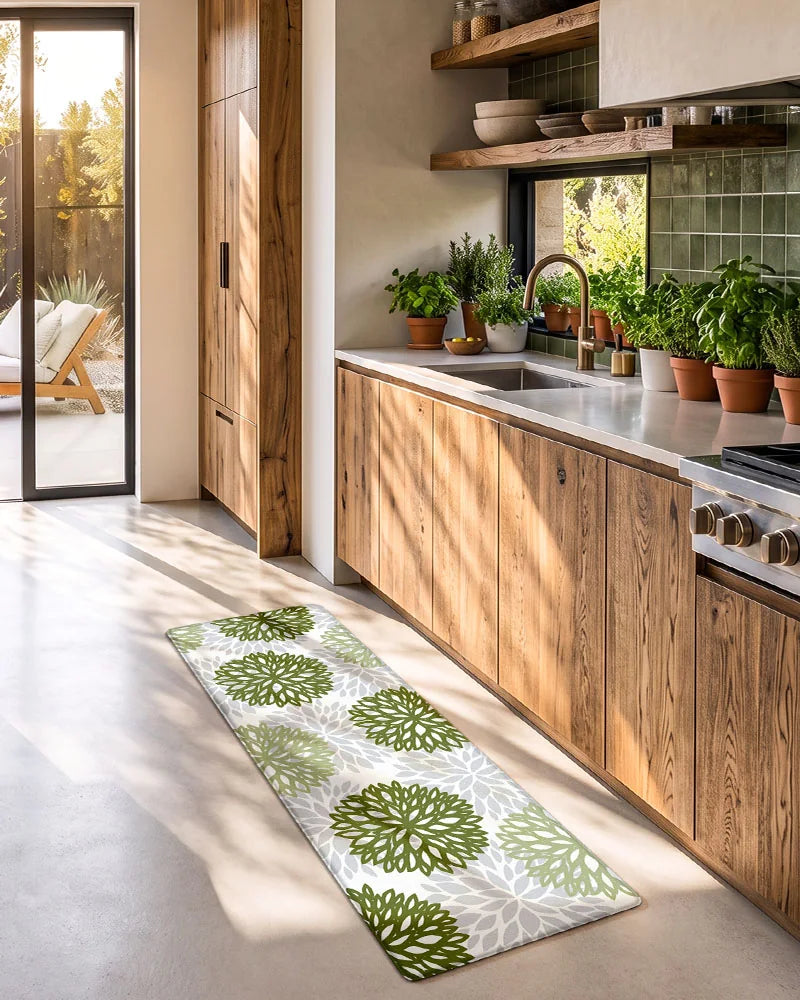 Sage Green dahlia floral anti-fatigue kitchen mat set in a sunlit kitchen with plants