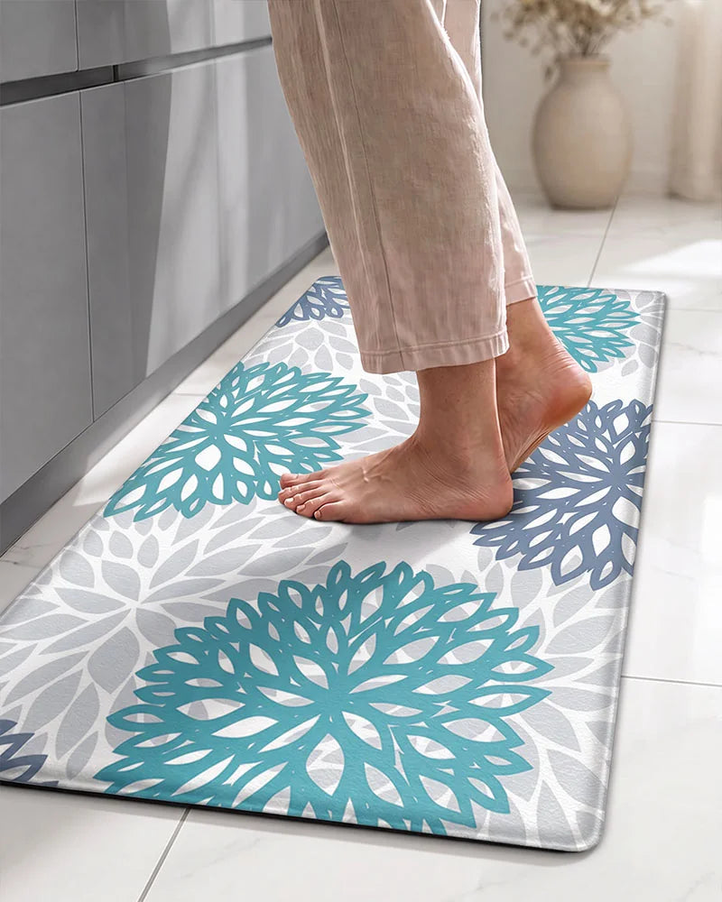 Bare feet on a Teal Blue cushioned dahlia floral anti-fatigue kitchen mat