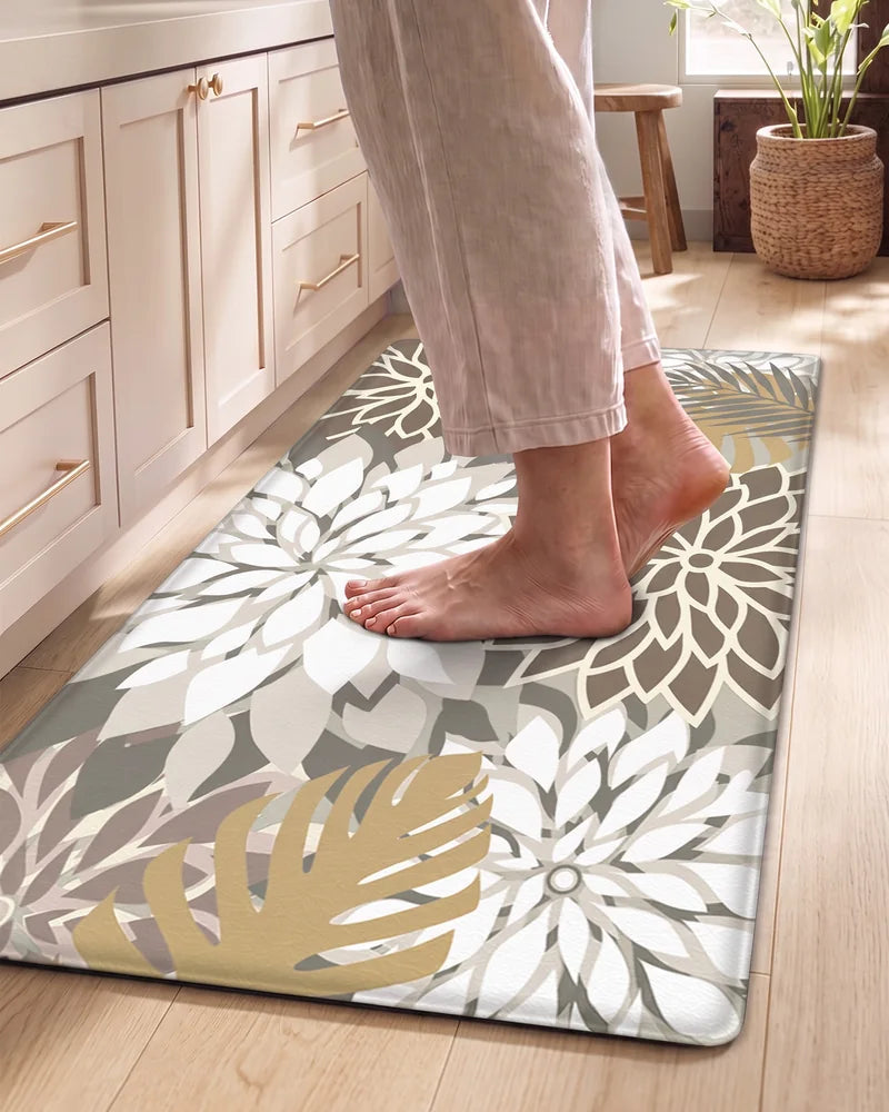 Bare feet standing on a Brown White floral cushioned anti-fatigue kitchen mat