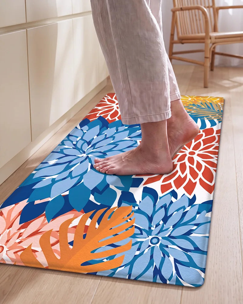 Bare feet standing on a Red Blue floral cushioned anti-fatigue kitchen mat