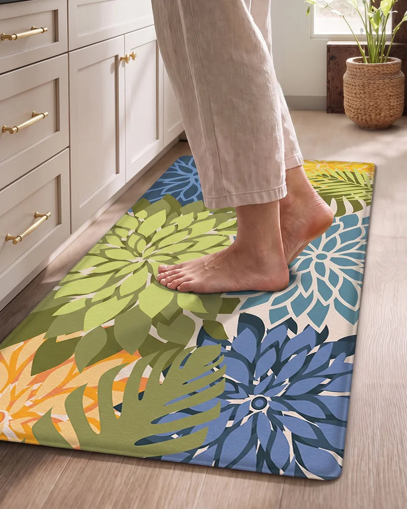 Bare feet standing on a Yellow Green floral cushioned anti-fatigue kitchen mat