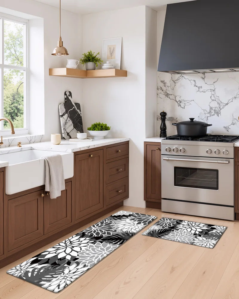 Black White floral anti-fatigue mats beside the sink and stove in a modern kitchen