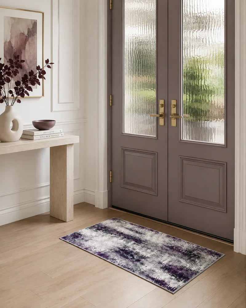 Gray purple washable abstract entryway rug beside frosted glass doors