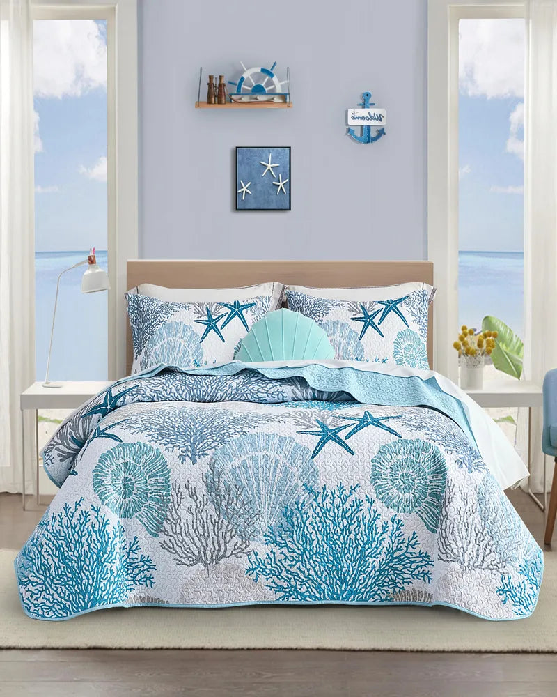Ocean-themed quilt set with coral, shells and starfish in a nautical bedroom