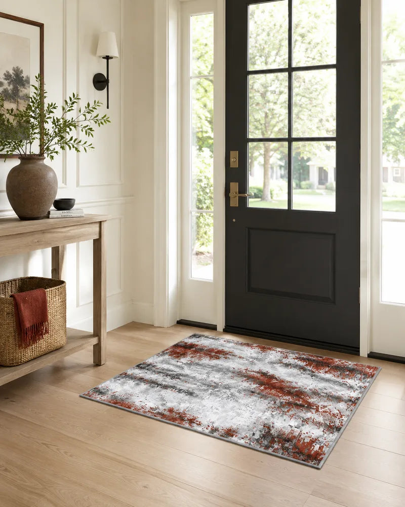 Rust red non-slip abstract entryway rug in front of a black door