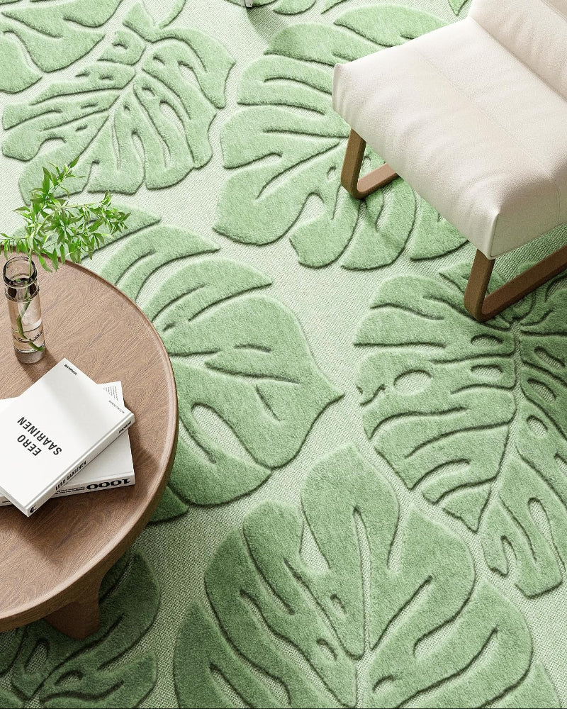 Close-up of the soft plush sage green Monstera rug surface