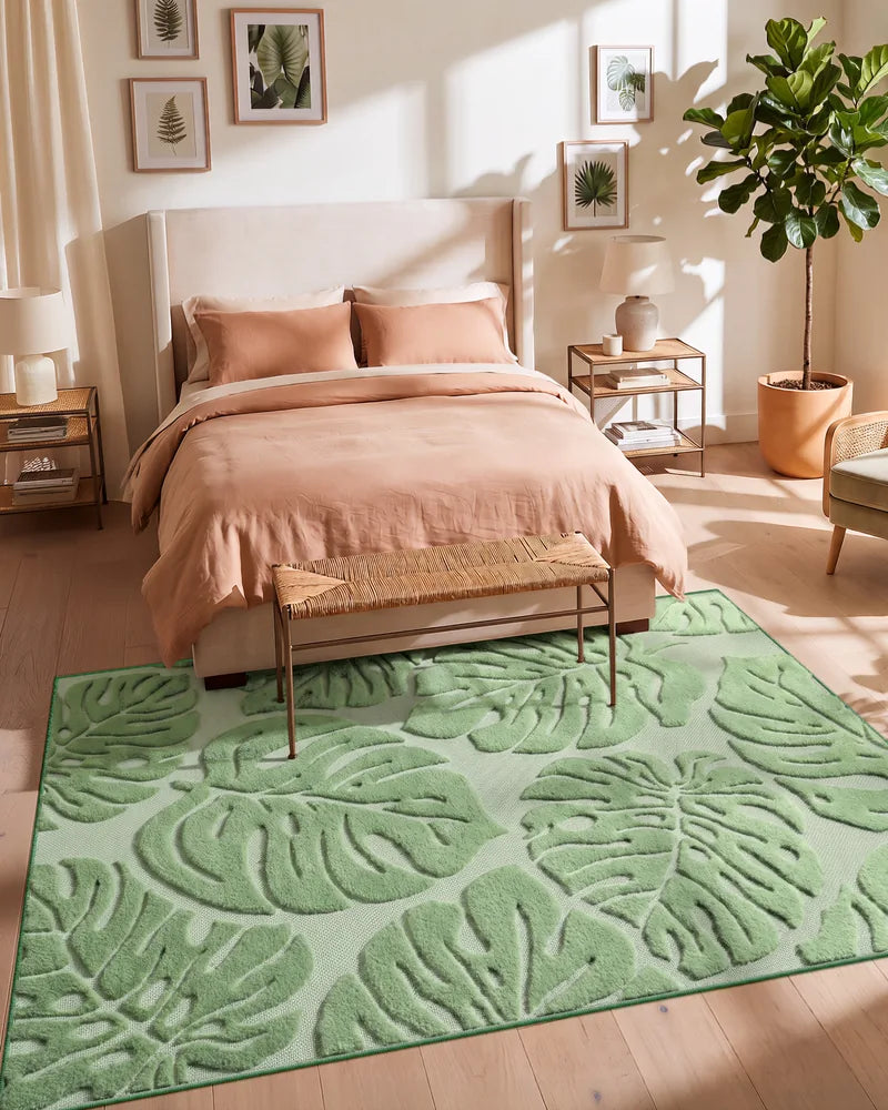 5 x 7 washable botanical rug beside a bed in a warm bedroom