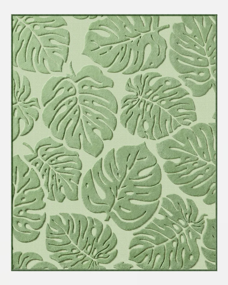 Sage green Monstera washable area rug with raised leaf texture in 8 x 10 size