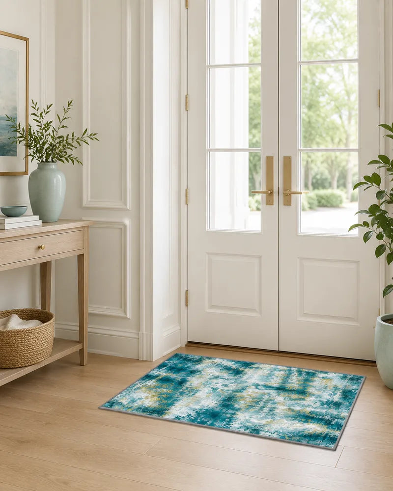 Teal washable abstract entryway rug beside white glass doors