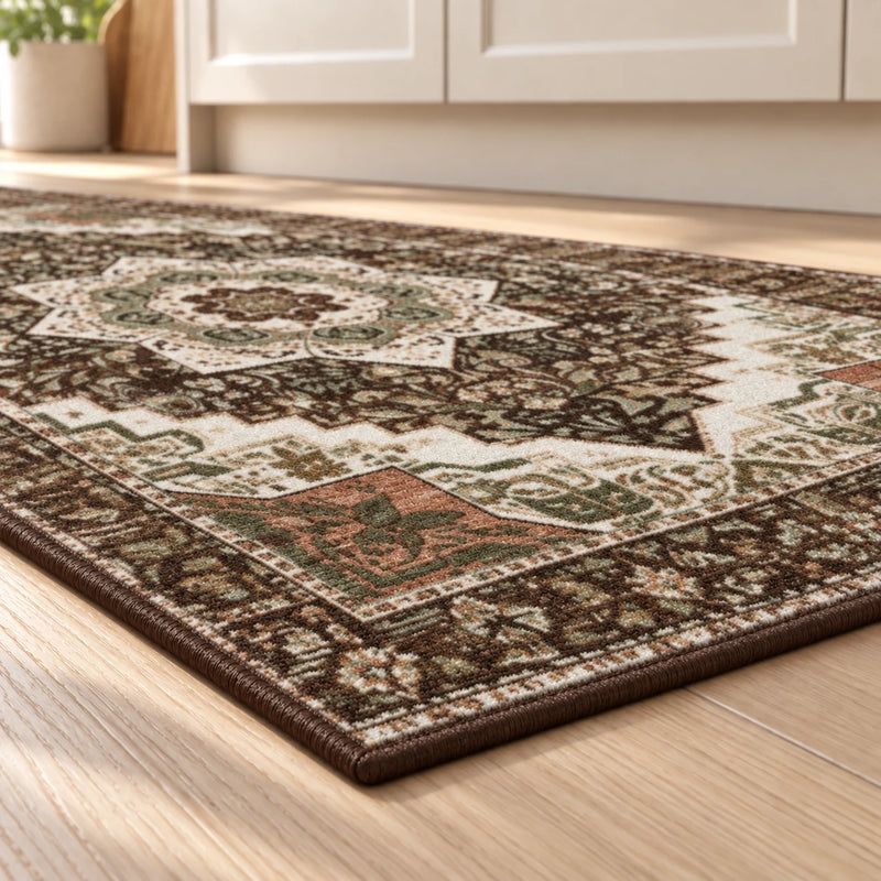 Close-up of the low-pile surface and brown bound edge on a vintage boho kitchen rug