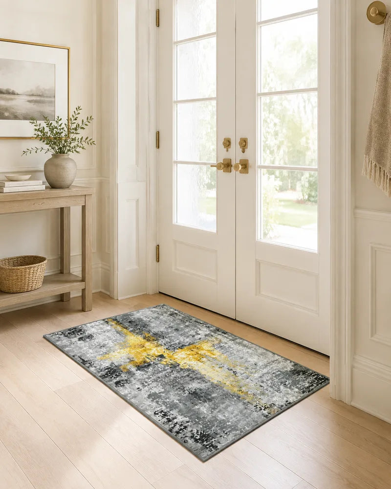 Yellow gray non-slip abstract entryway rug beside a glass door
