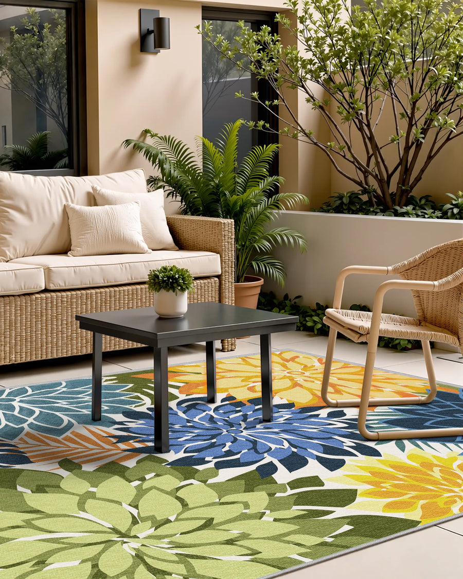 Floral outdoor rug styled with wicker seating on a covered patio